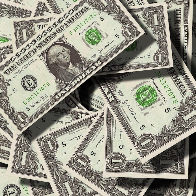One Dollar bills on top of each other